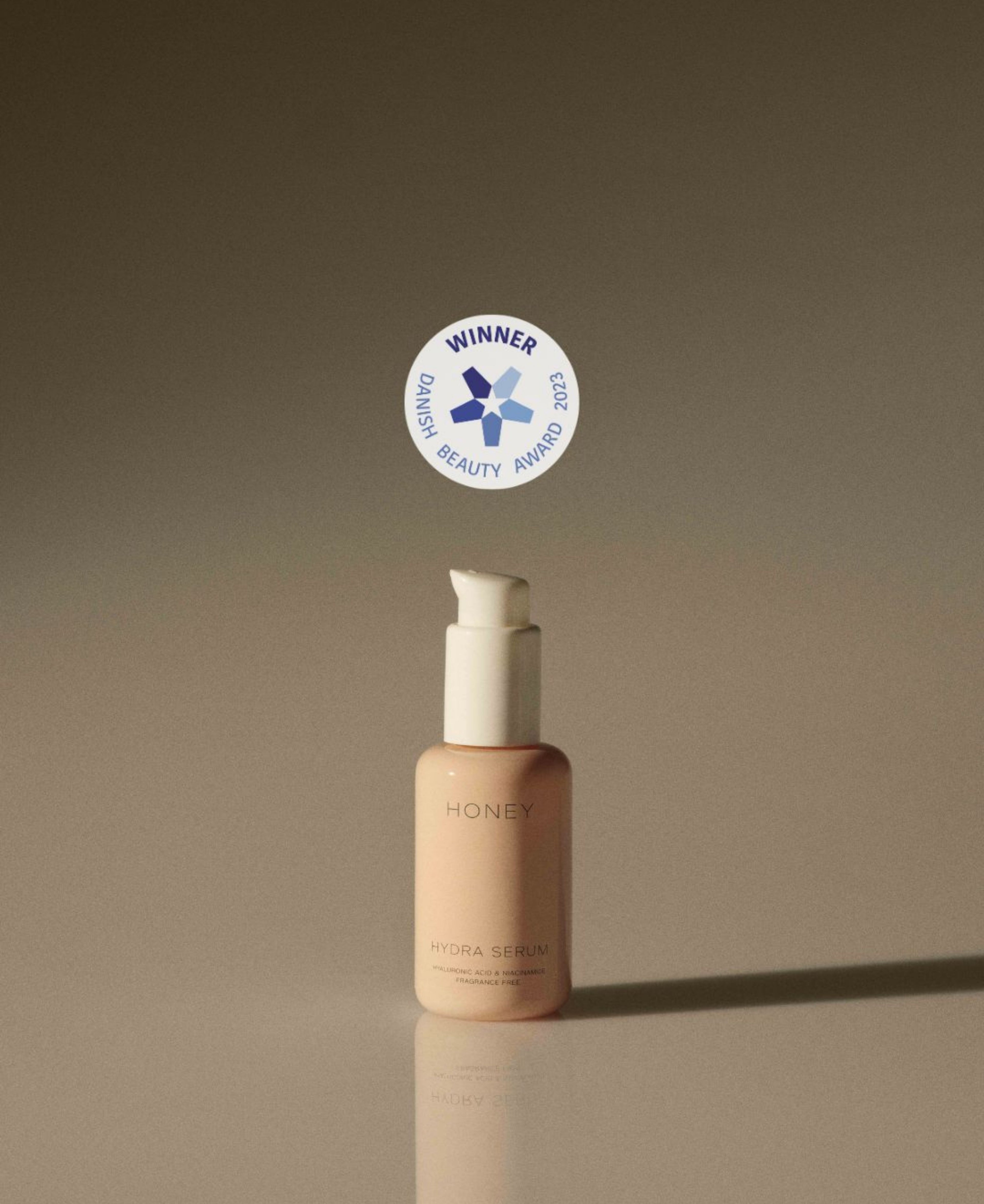 Natural hydrating serum in dusty pink bottle with white cap - clean skincare