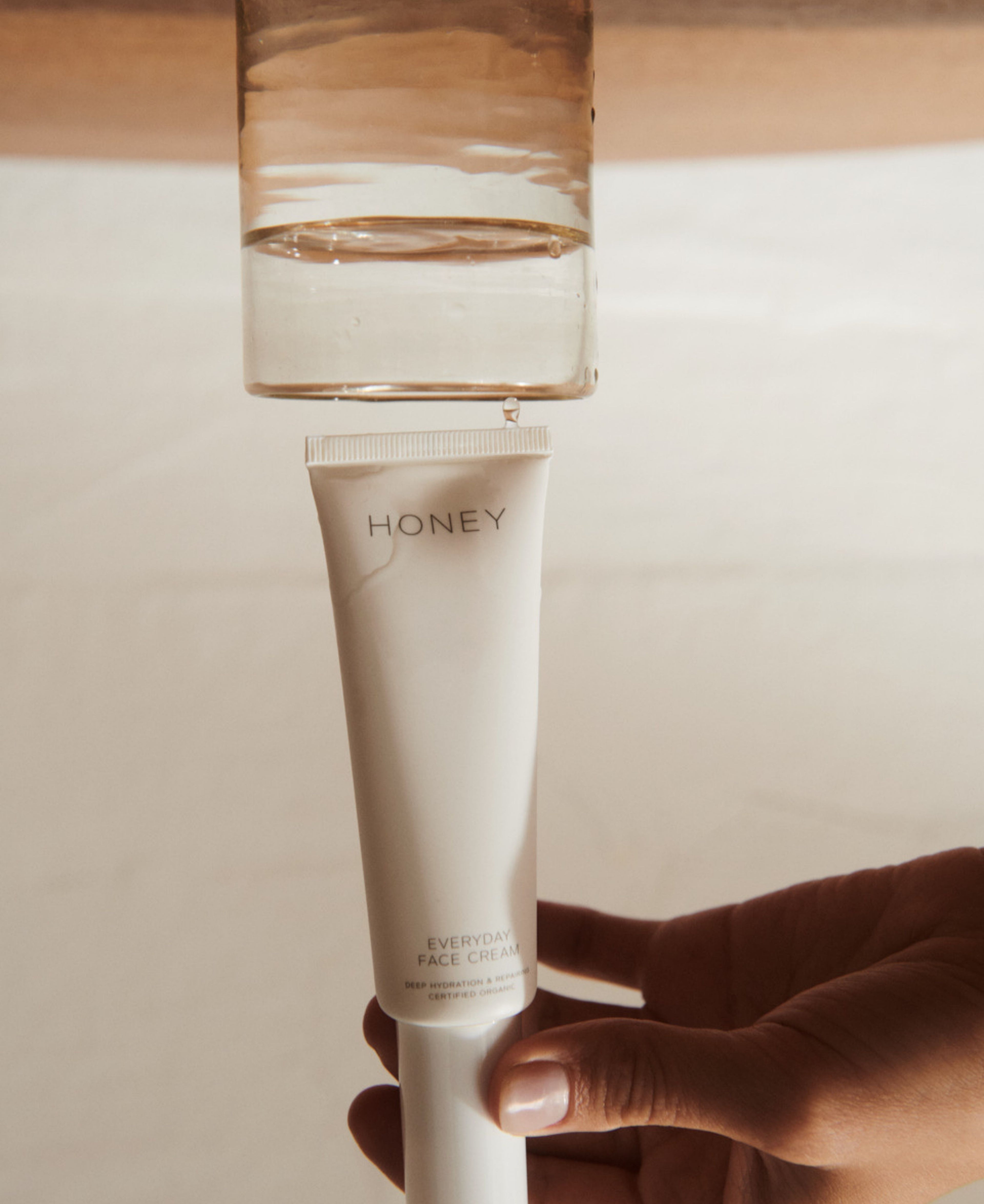 Natural fragrance-free day face cream in light pink tube with white cap - clean skincare