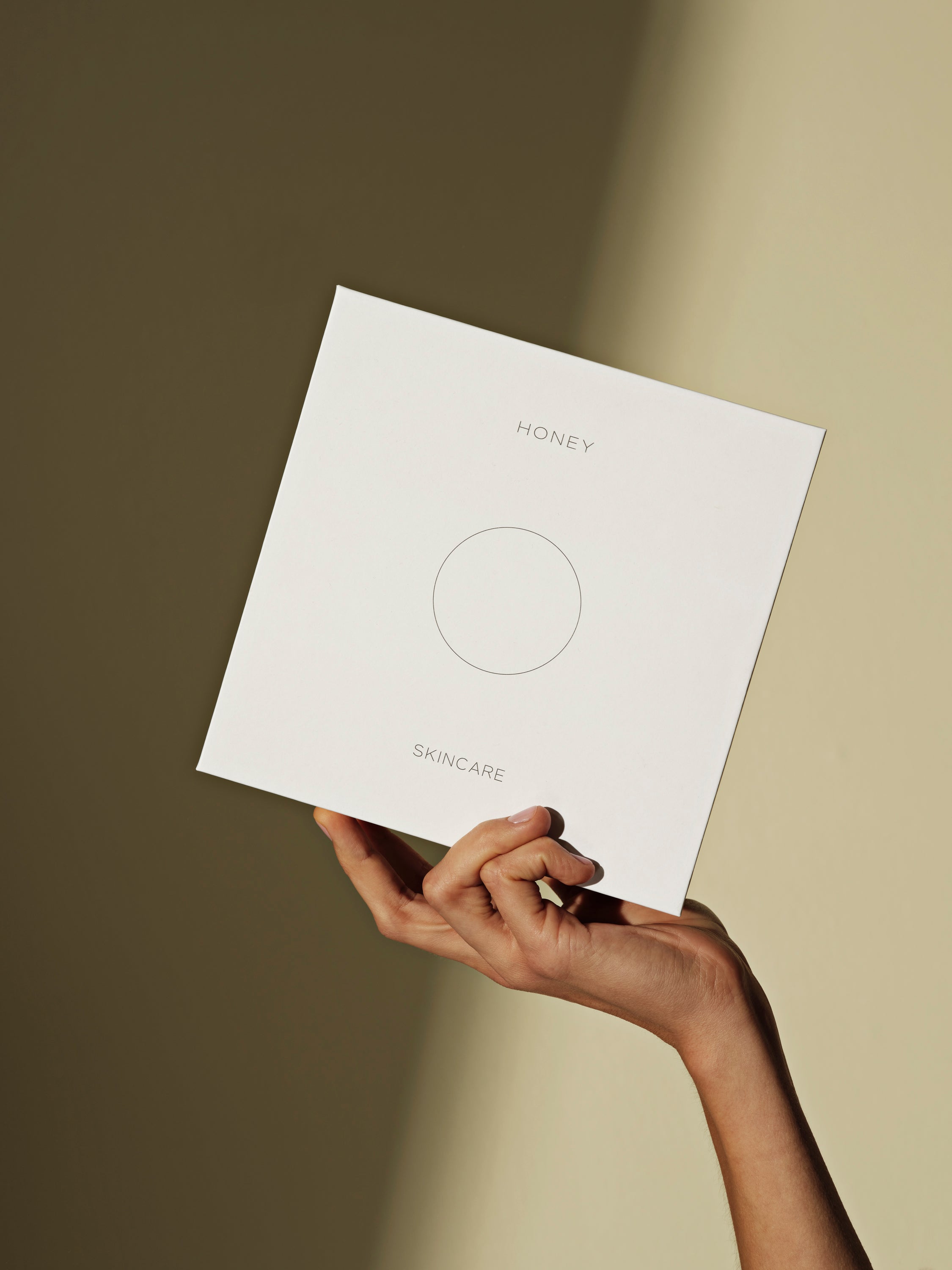 Hand holding gift box with 3 products natural fragrance-free clean skincare