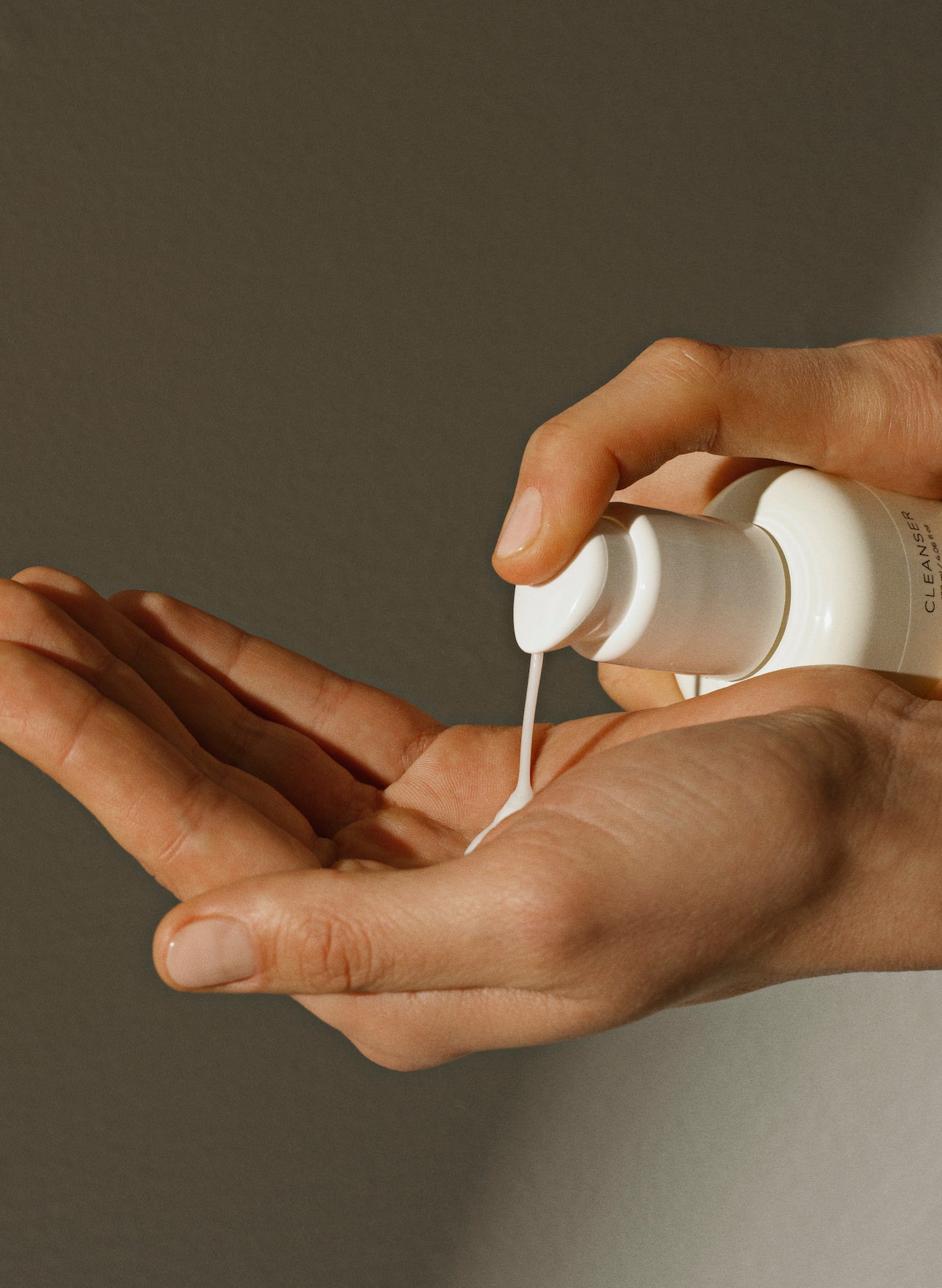 Hand pouring natural fragrance-free cleanser - face wash into hand