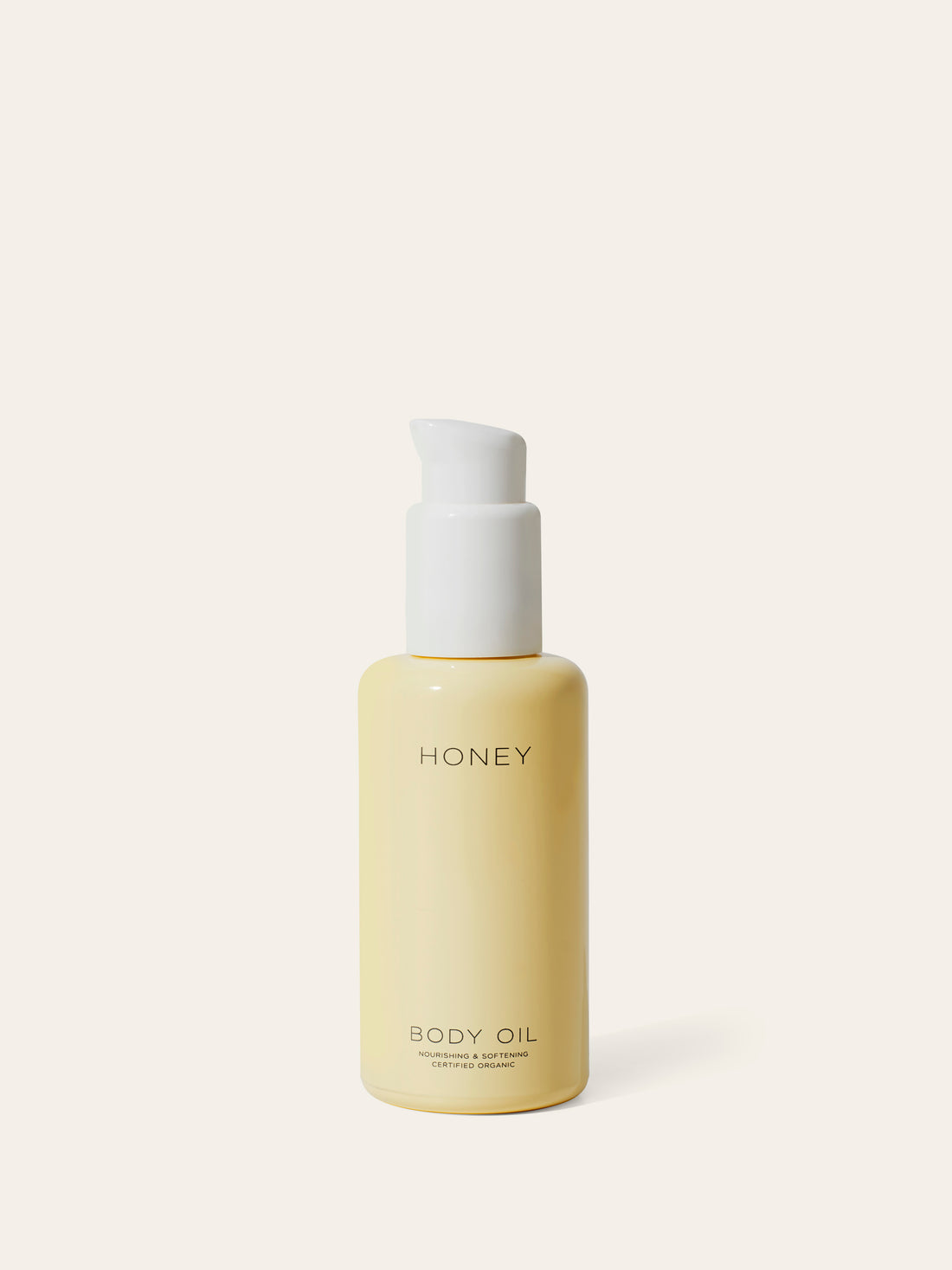 Natural clean skincare body oil in yellow bottle with white cap 