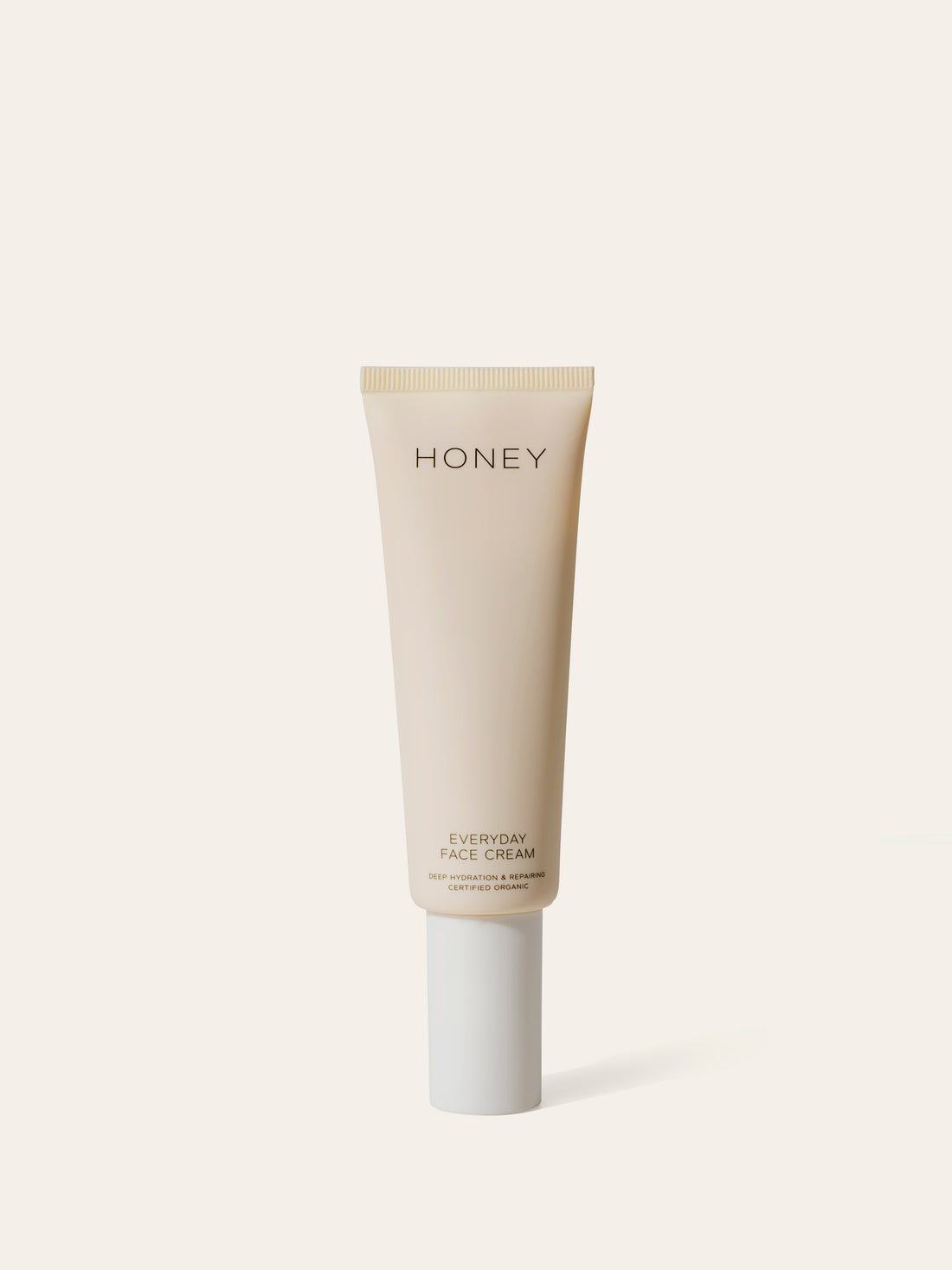 Natural fragrance-free day face cream in light pink tube with white cap - clean skincare